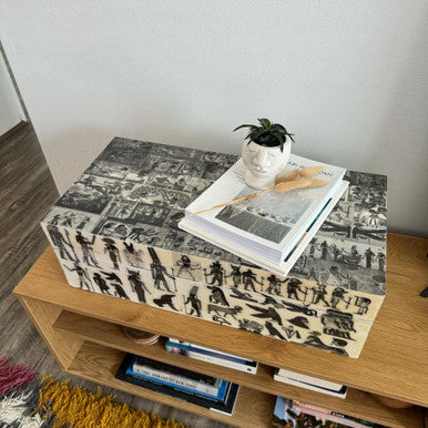 Decorative box with black and white pattern on a wooden surface