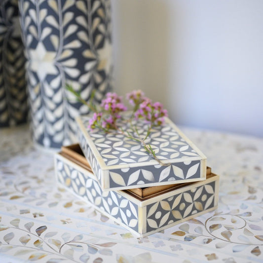 Decorative box with floral pattern on a textured surface