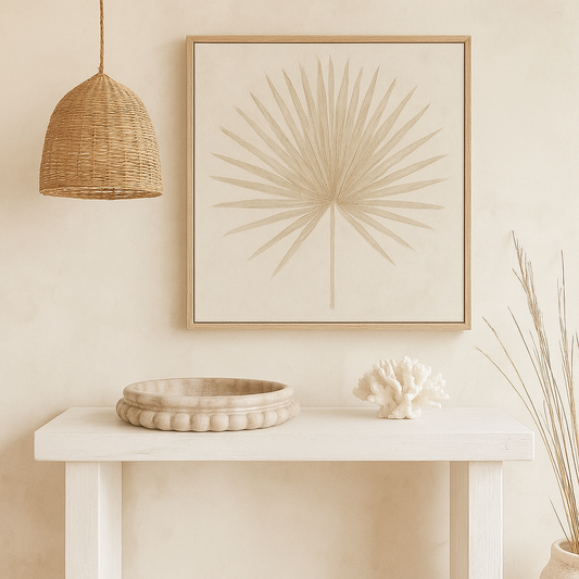 Beige wall with framed abstract art, wicker basket, and decorative items on a white table.
