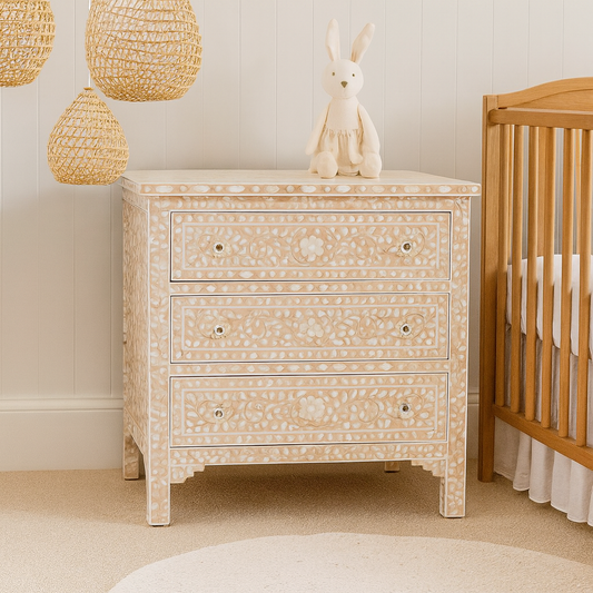 Decorative chest of drawers with a crib in a nursery setting