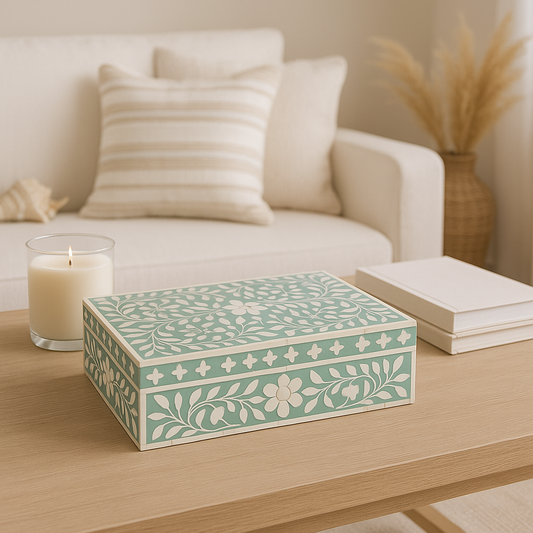 Decorative box with floral patterns on a wooden table in a cozy living room setting.