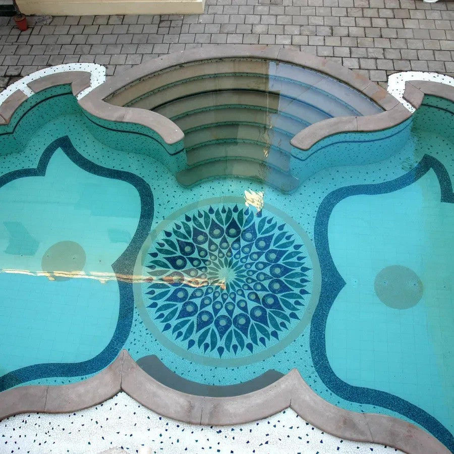 Decorative pool with geometric patterns on a tiled floor Decorative pool with geometric patterns on a tiled floor