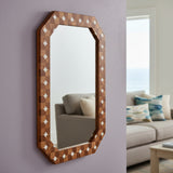 Decorative wall mirror with wooden frame in a living room setting