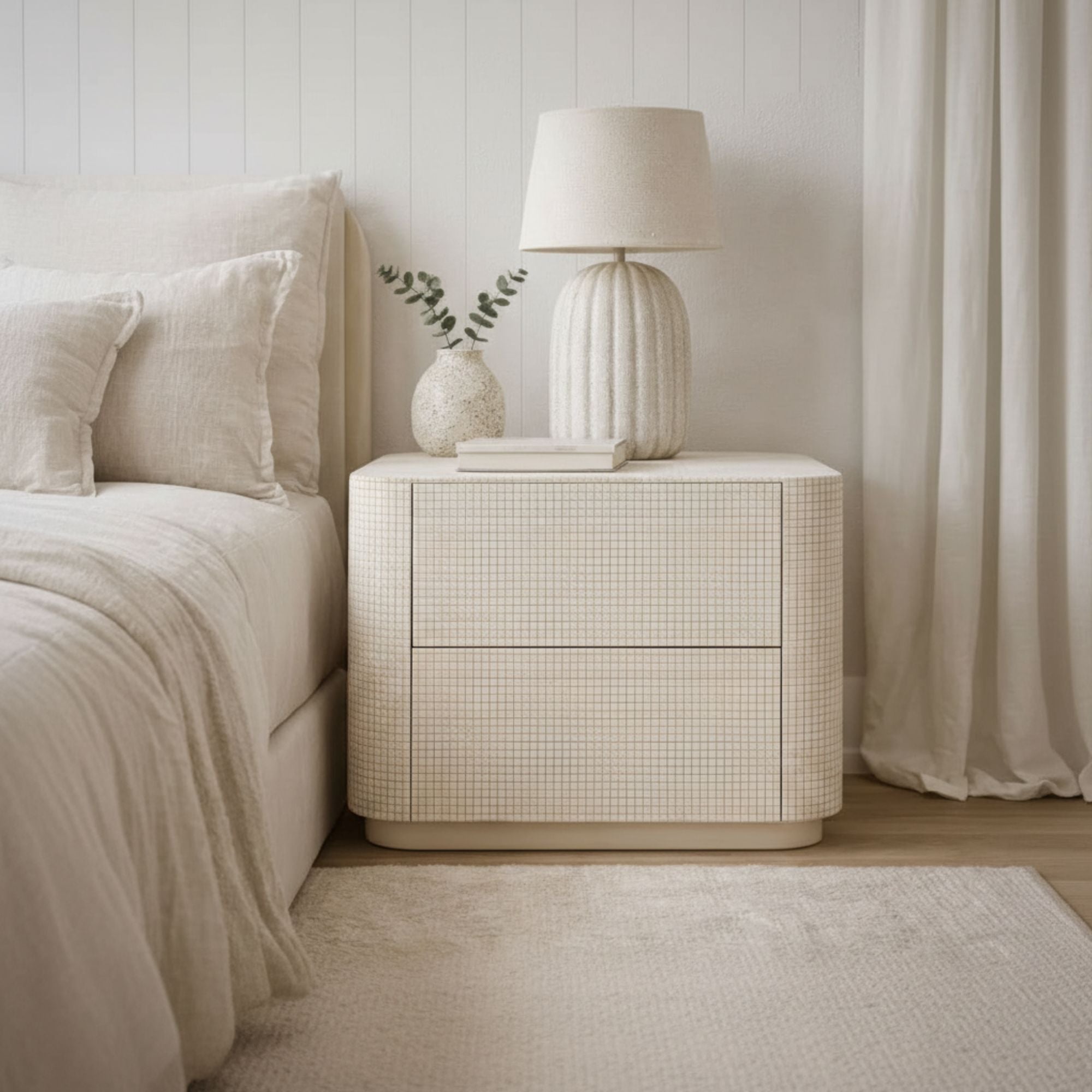 Neatly arranged bedroom with a nightstand, lamp, and bed.