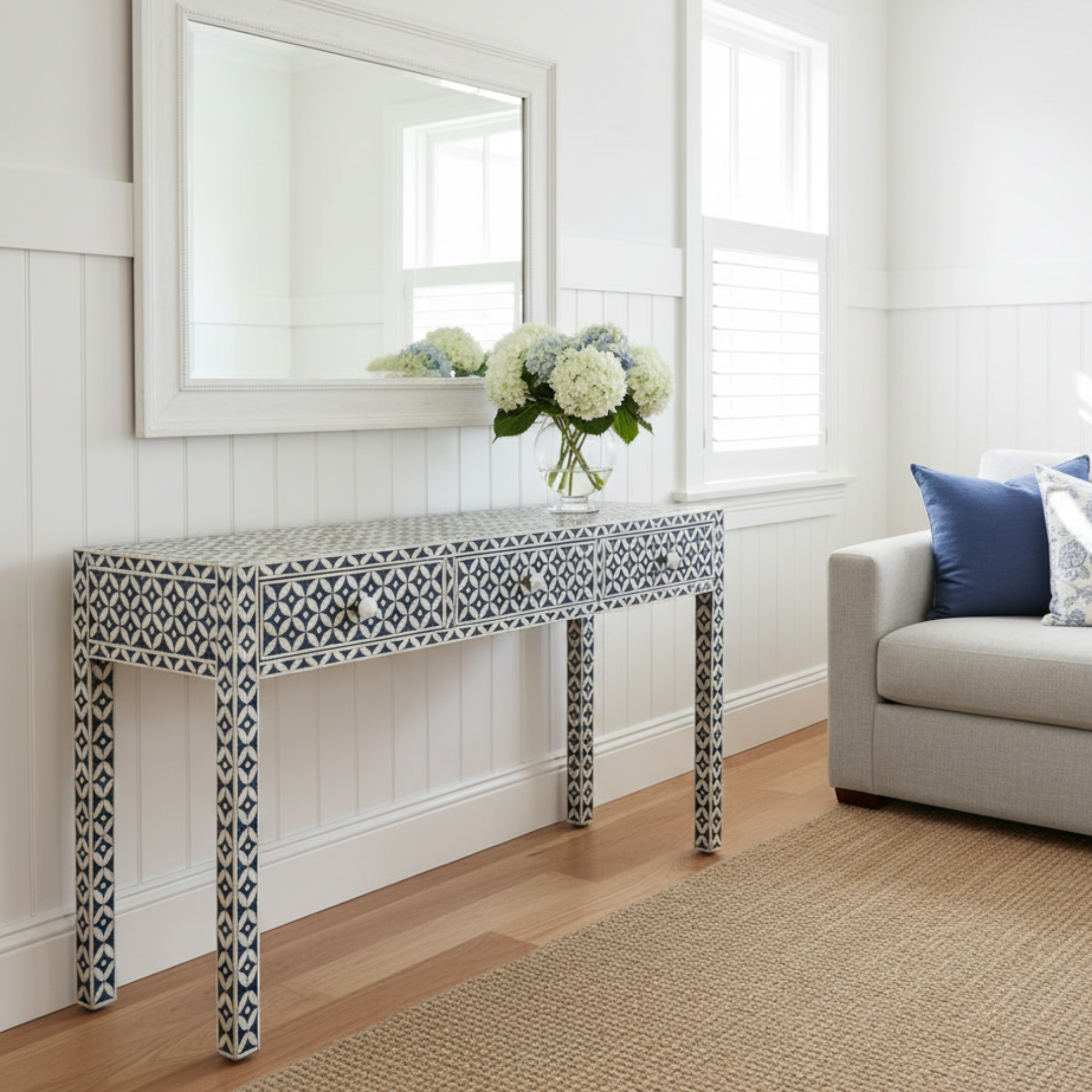 Decorative console table with floral arrangement in a living room setting