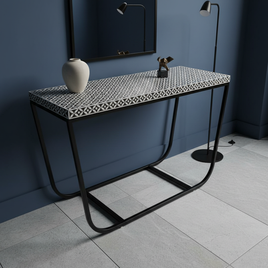 Console table with decorative items against a blue wall