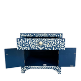 Blue cabinet with white floral patterns on a white background