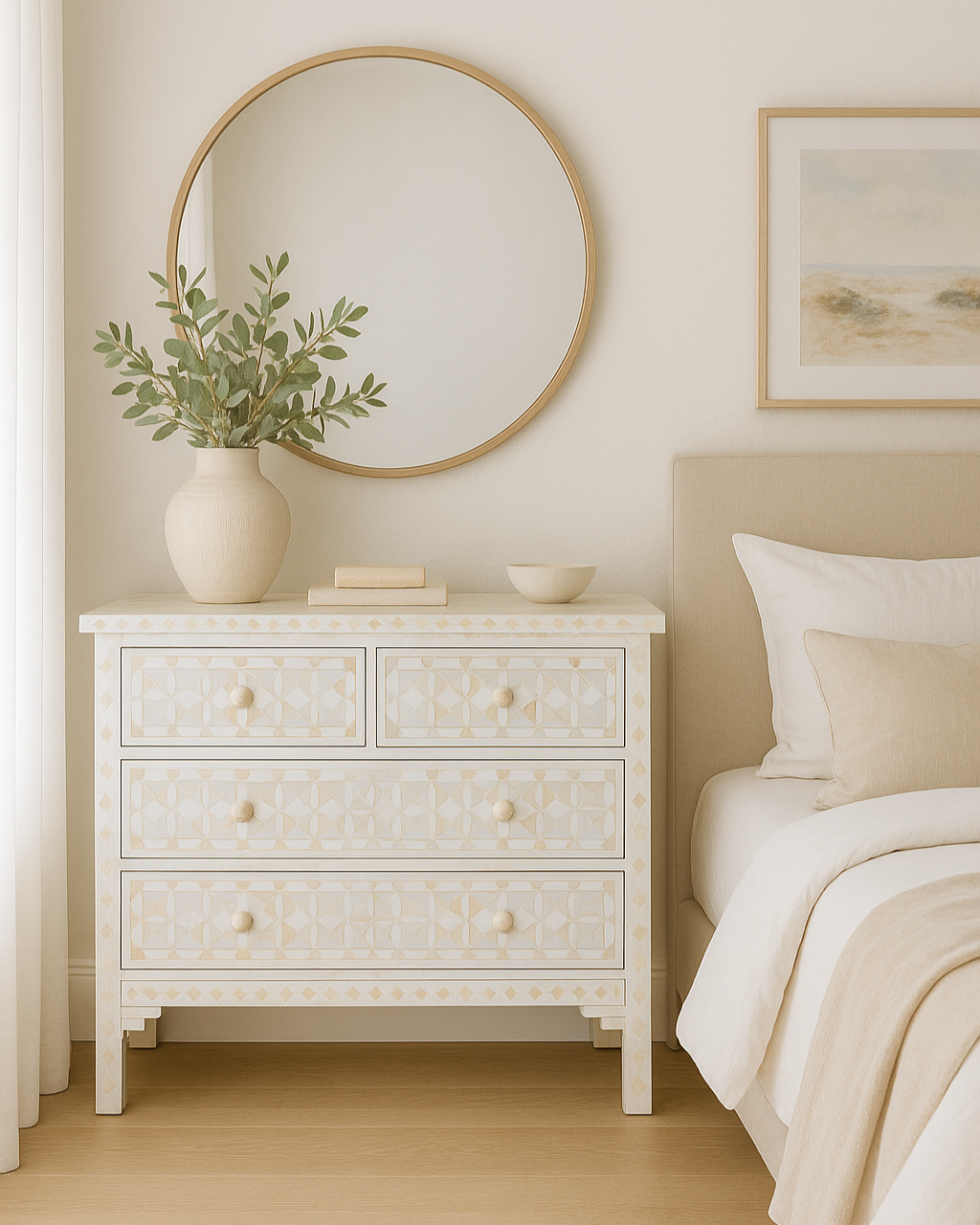 Neatly arranged bedroom with a white dresser, round mirror, and bed.