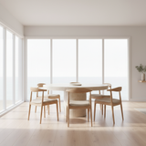 Modern dining set with wooden chairs and table in a bright room with large windows.