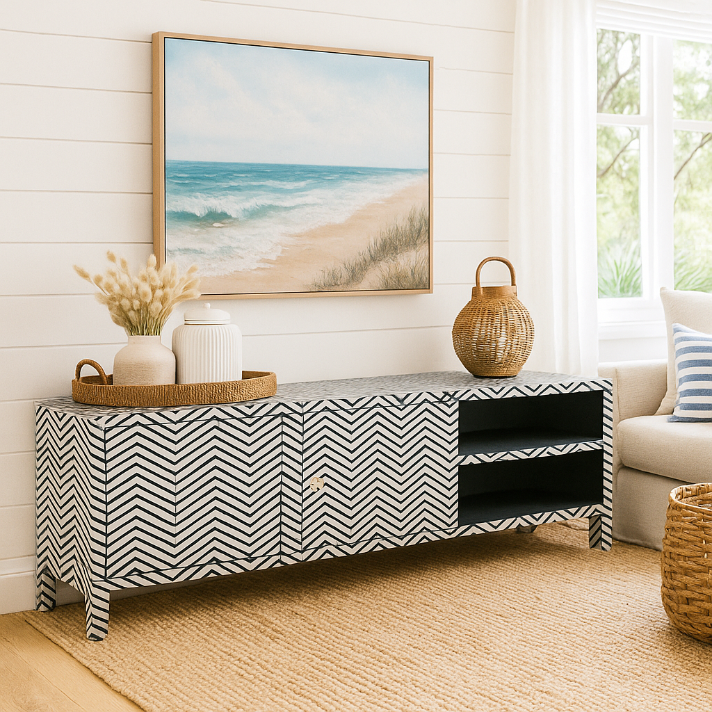 Living room with a chevron-patterned console table, beach-themed artwork, and decorative items.