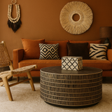 Cozy living room with brown sofa, decorative pillows, and a round coffee table.