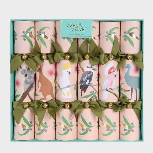 Set of decorative crackers with animal illustrations and green ribbons in a box, branded 'Vixen & Velvet'.