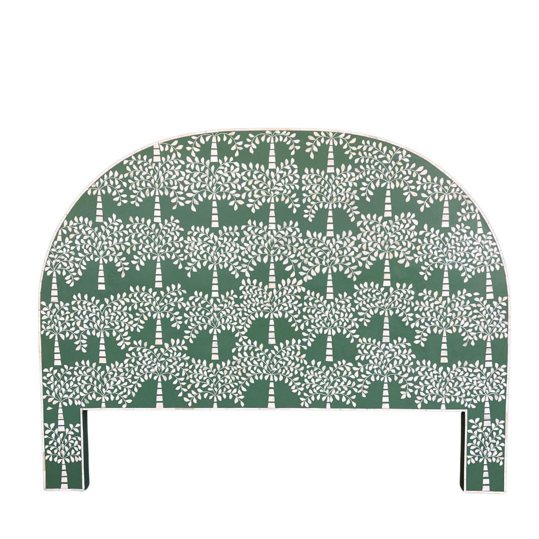A green bedhead featuring a palm tree motif made from camel bone, with a semi-circular shape.