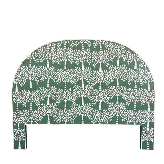 A green bedhead featuring a palm tree motif made from camel bone, with a semi-circular shape.