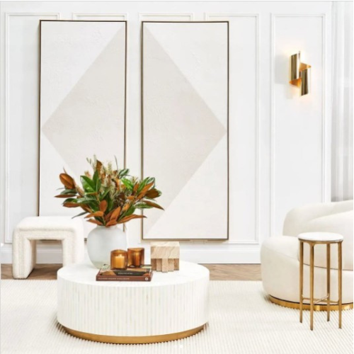 Modern living room with a white sofa, coffee table, and decorative elements.
