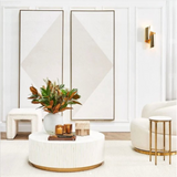 Modern living room with a white sofa, coffee table, and decorative elements.