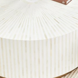 Close-up of a white pleated fabric with a brown border