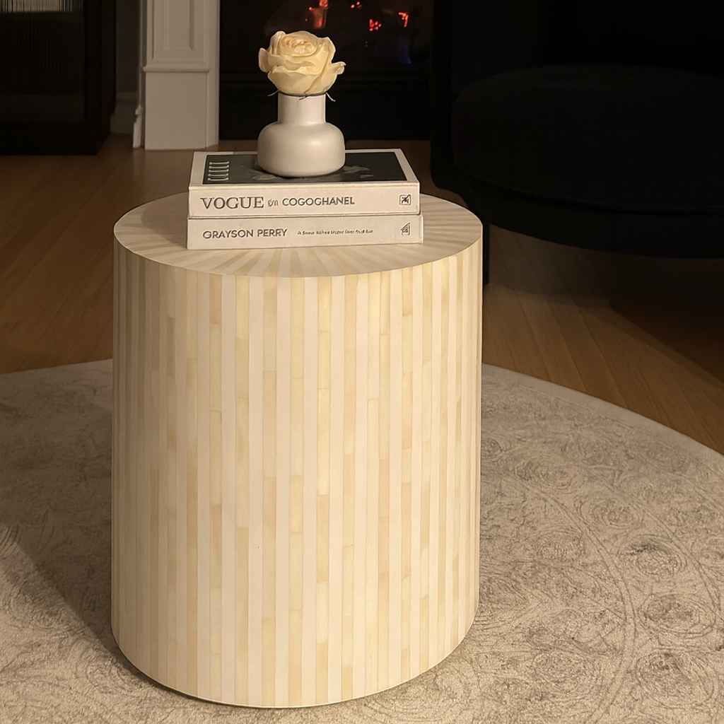 Wooden side table with books and a decorative item on top in a home setting.