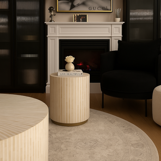 Modern living room with a fireplace, black sofa, and decorative side table.