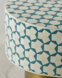 Round stool with geometric blue and white pattern on a plain background