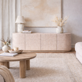 Modern living room with a wooden coffee table and sideboard.