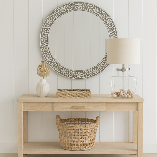 Wooden console table with decorative items against a white paneled wall