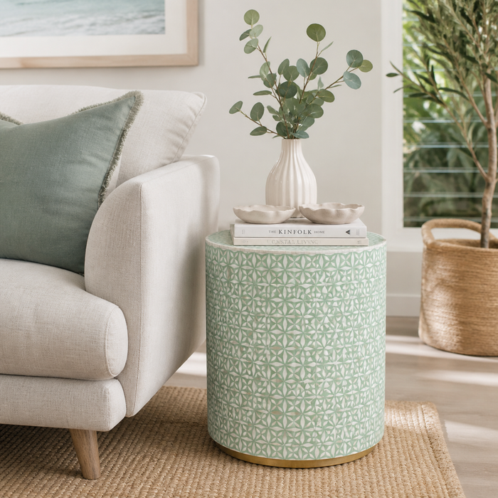 Patterned side table in a living room with a sofa and plant