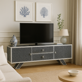 Modern living room with a decorative TV stand, television, and decor items.
