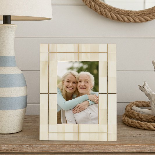 Decorative photo frame with a picture of two people hugging on a wooden surface.