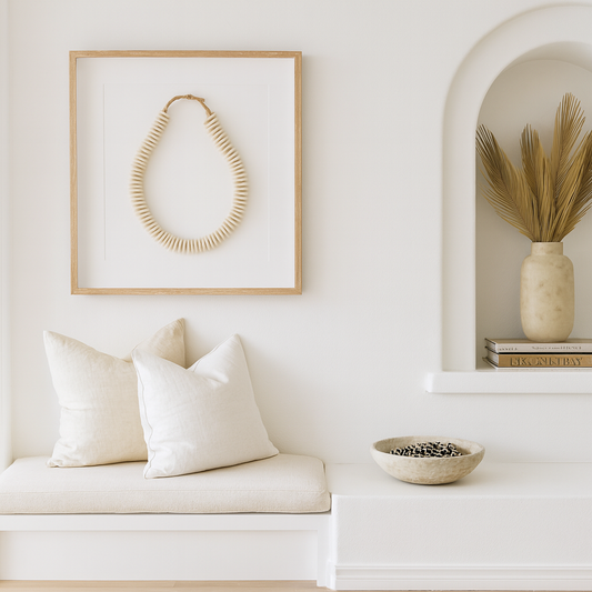 Nest living room with white walls, a bench, and decorative items.