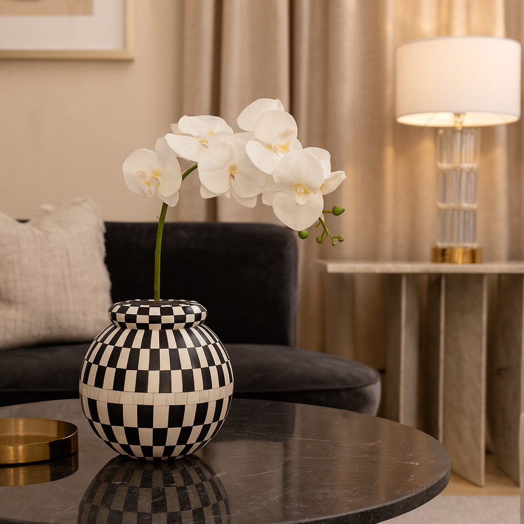 Decorative vase with white flowers on a table in a living room setting