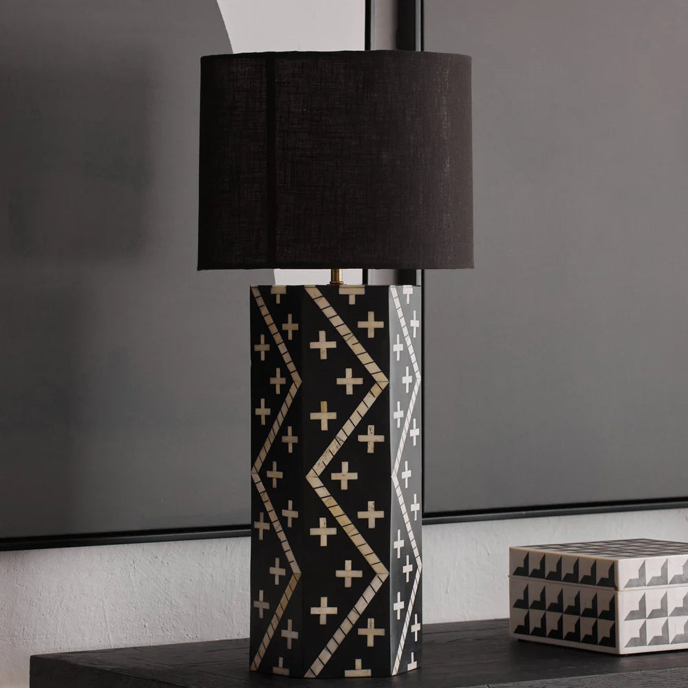 Decorative table lamp with geometric pattern on a dark surface