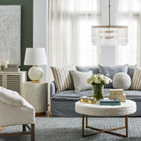Modern living room with gray sofa, white coffee table, and decorative pillows.