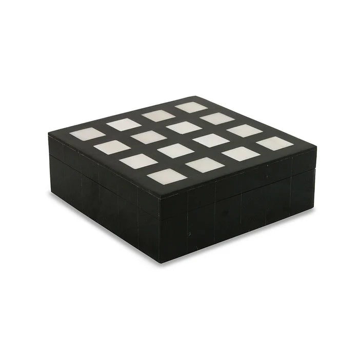 Black jewelry box with white stones on a white background
