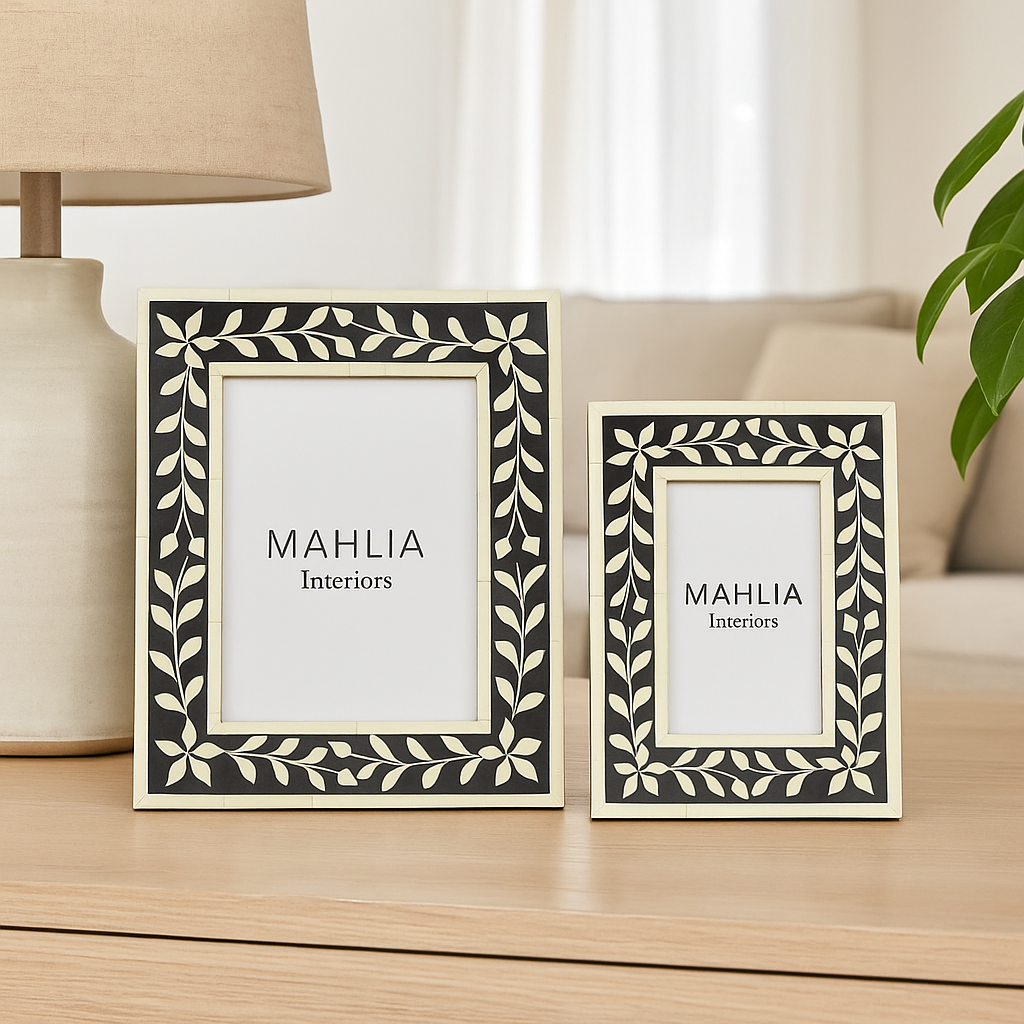 Two decorative picture frames with 'MAHLIA Interiors' branding on a wooden surface.