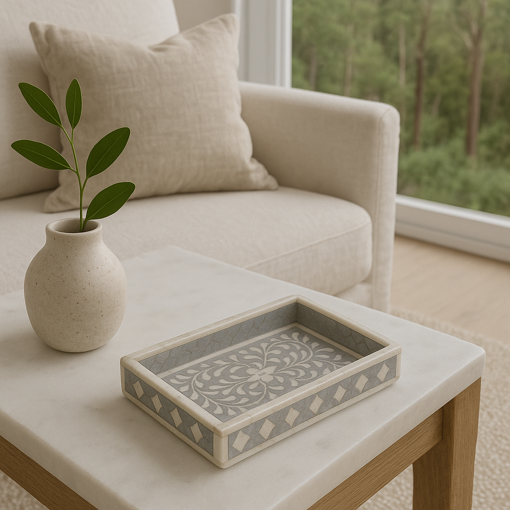 Decorative box on a coffee table with a vase and plant in a living room setting