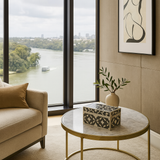 Modern living room with a view of a river and cityscape
