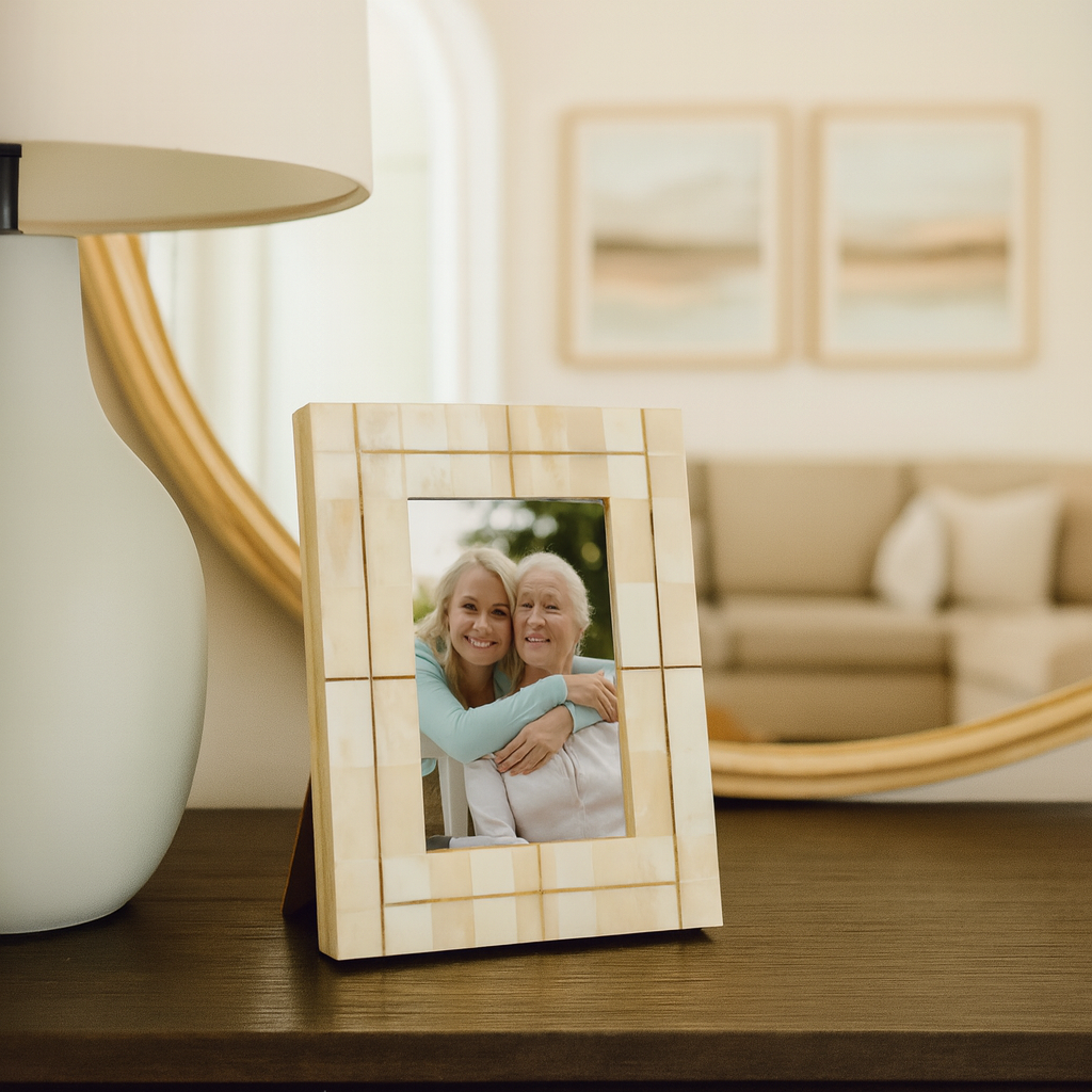 Wooden photo frame with a picture of two women on a table in a living room.