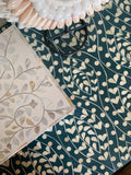 Close-up of decorative tiles with leaf patterns on a teal background