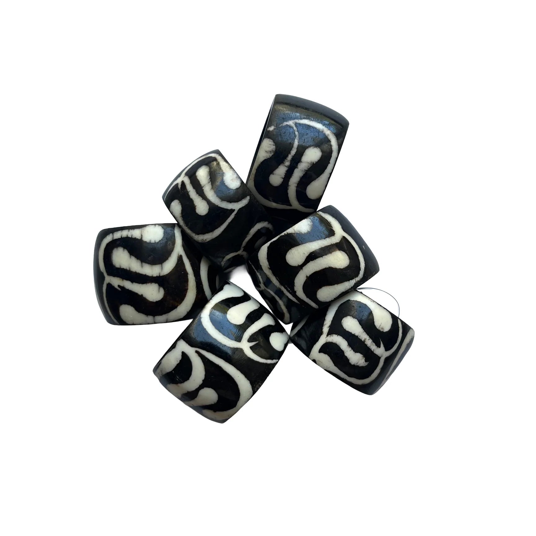 Black and white patterned beads on a white background
