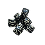 Black and white patterned beads on a white background