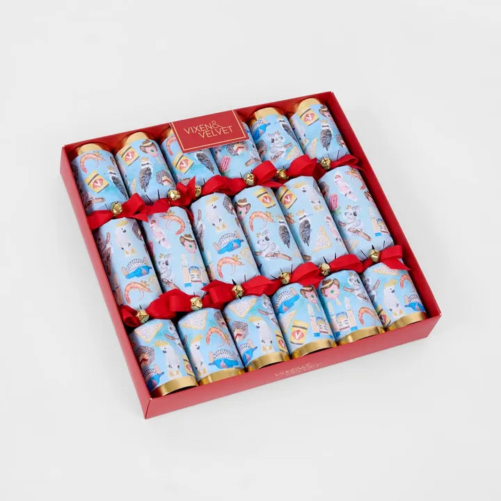 Box of Christmas crackers with blue designs and red ribbons on a white background