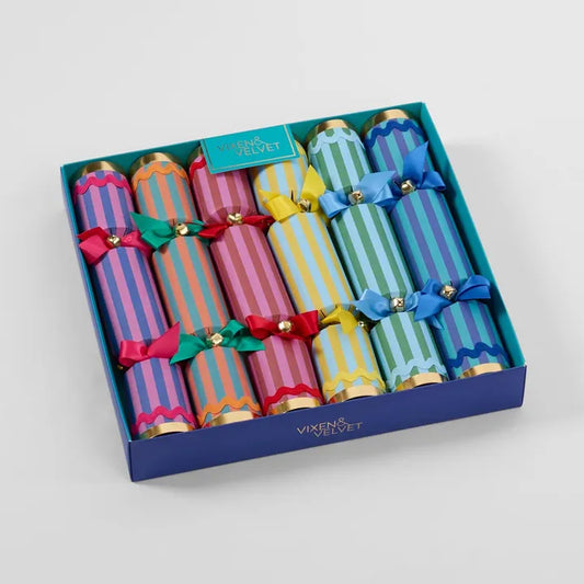 Set of colorful Christmas crackers in a blue box with 'Vixen & Velvet' branding.