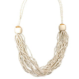 Necklace with multiple strands of pearls and wooden beads on a white background