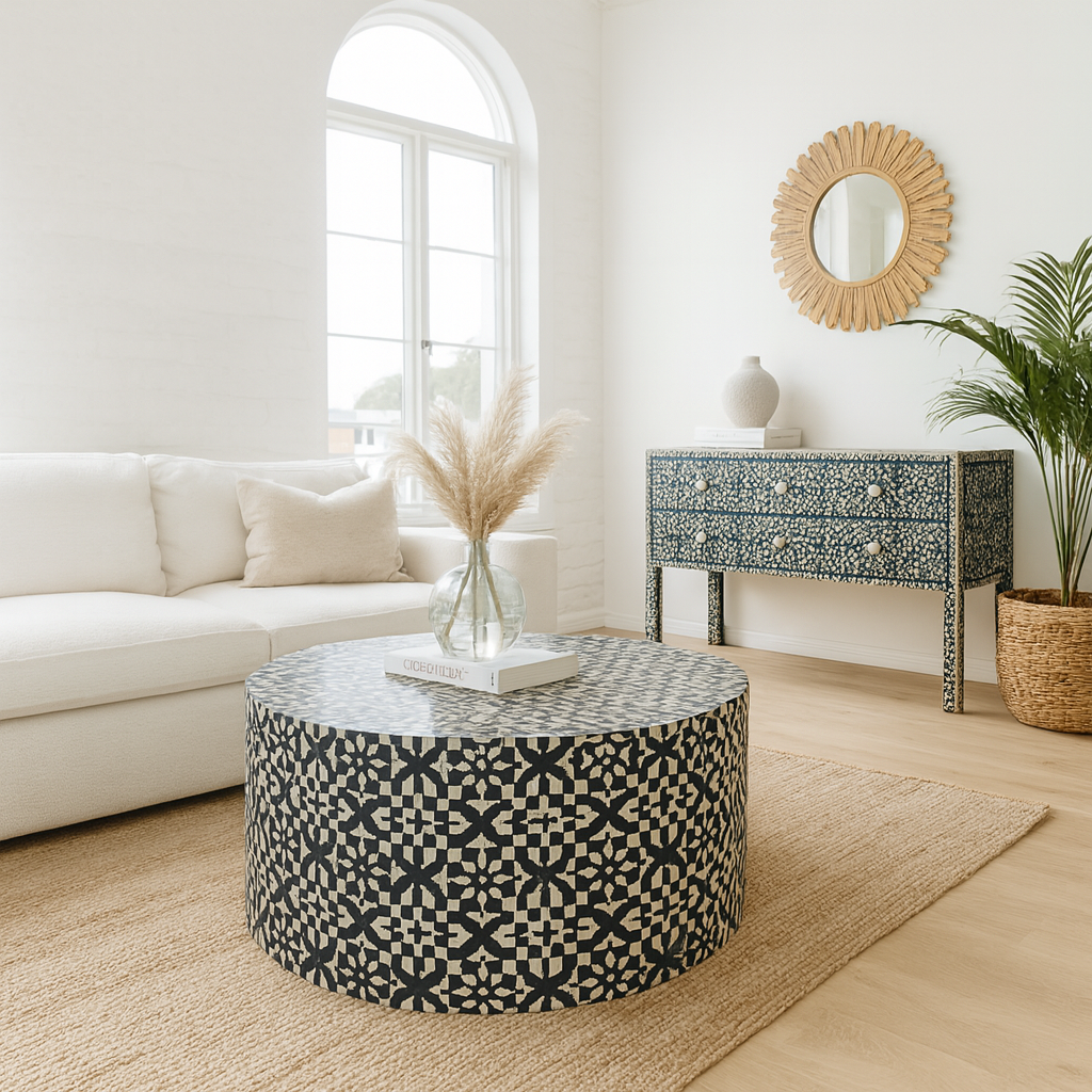Living room with a patterned ottoman, white sofa, and decorative mirror.
