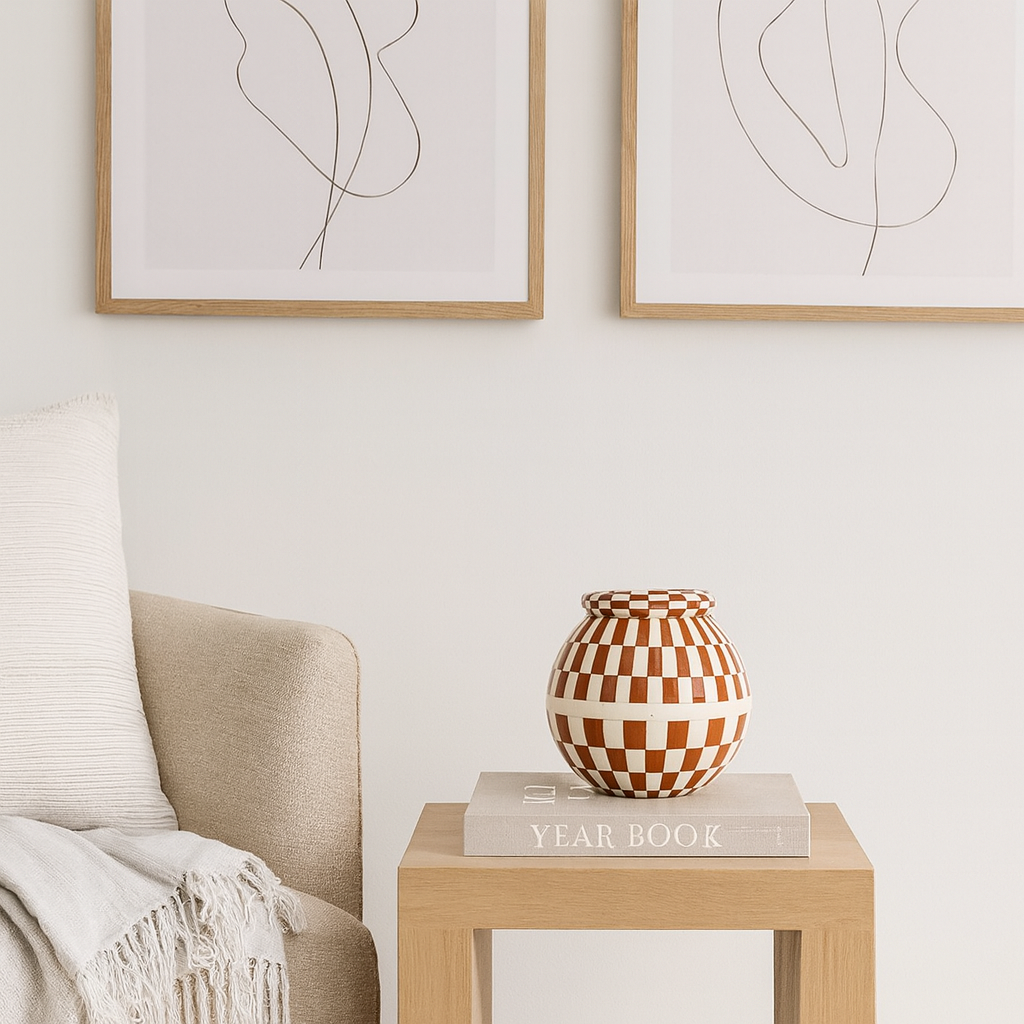 Decorative vase on a book with abstract art on the wall
