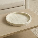 Round wooden tray on a wooden surface with a neutral background