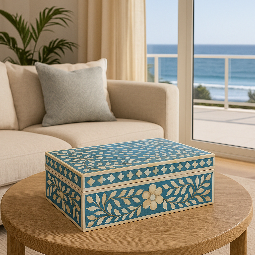 Decorative blue and white box on a wooden table with a living room and ocean view in the background