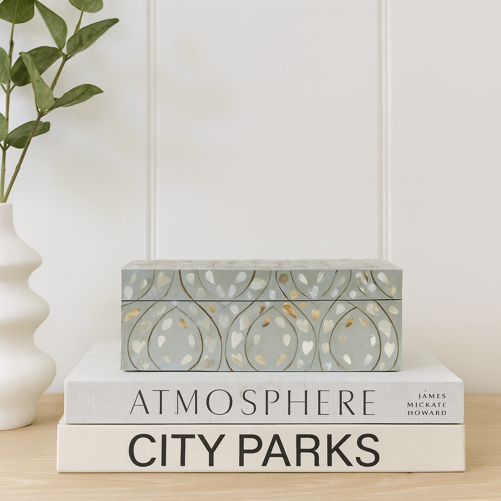 Decorative book with 'Atmosphere City Parks' on a wooden surface with a plant in the background