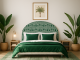 Green-themed bedroom with patterned headboard, matching bedding, and plants.